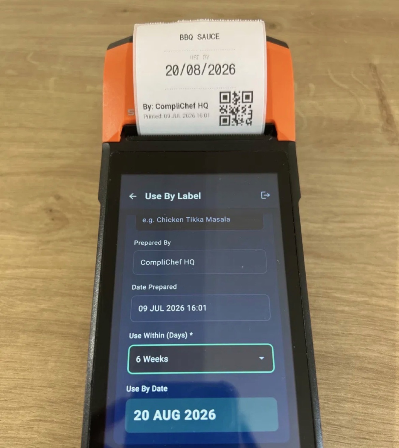 Printing a use-by label on the CompliChef Labels device — BBQ Sauce, use by 20 Aug 2026